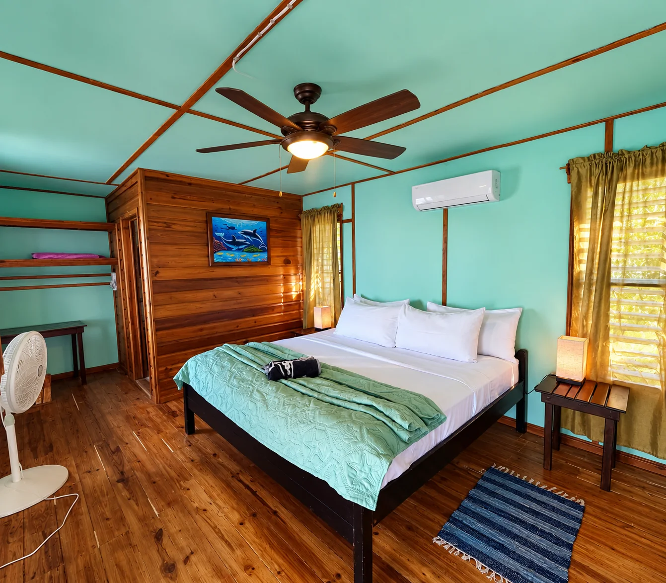 Wooden cabana bedroom with a ceiling fan