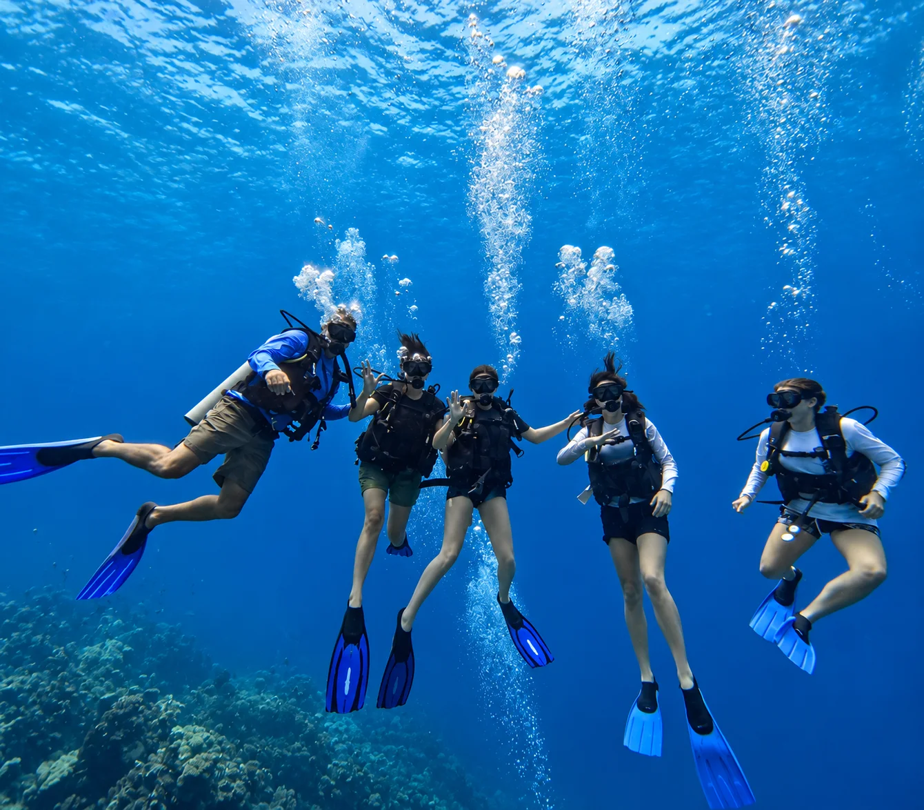 Scuba divers exploring blue water