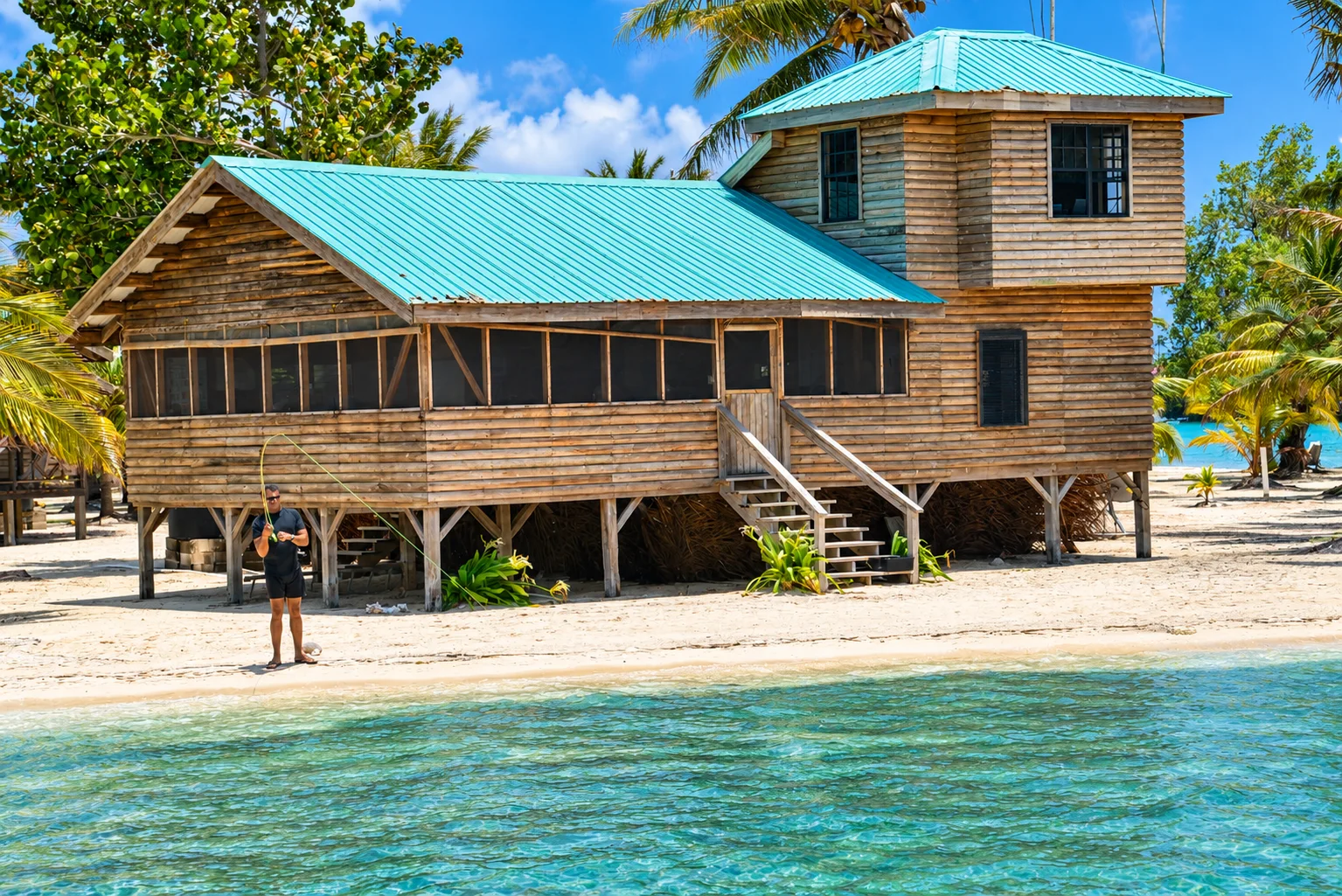 Wooden island house beside turquoise water